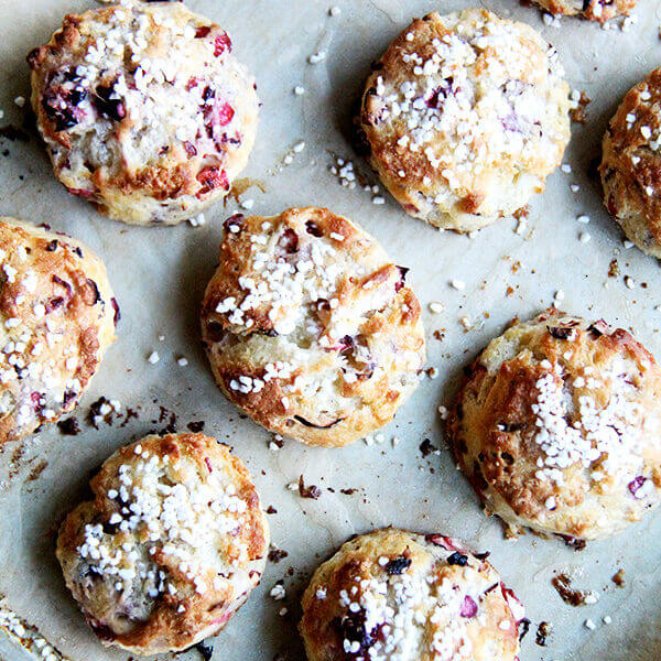 An overhead shot of a tray of freshly baked cranberry snow scones.