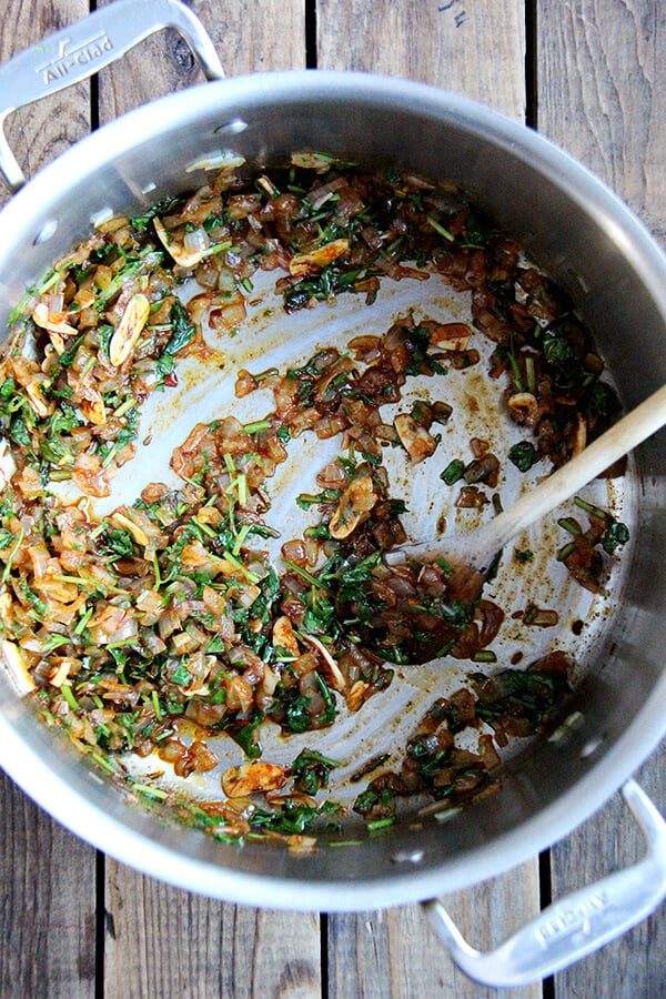 sauteing the onions, garlic, cilantro, and spices