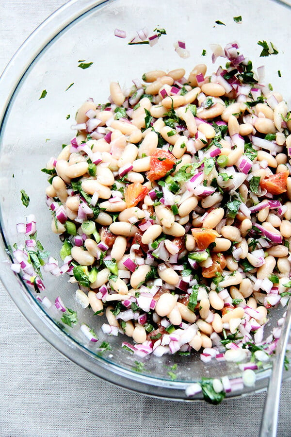 A large bowl of white bean and orange salsa.