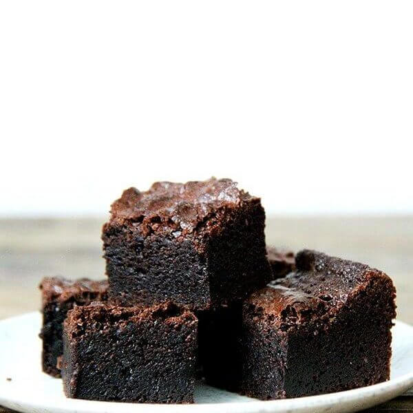 A stack of the best ever fudgy brownie recipe on a plate.