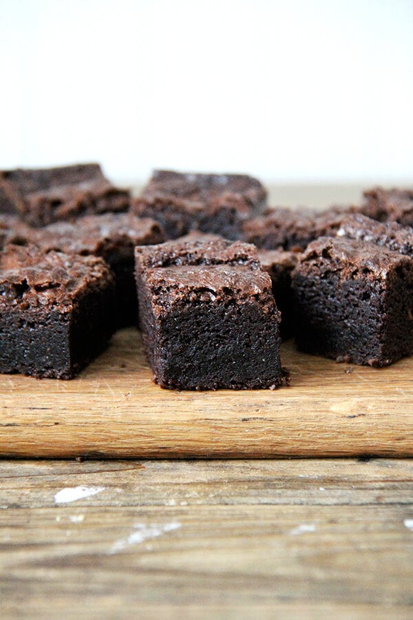 Side view of cut brownies on a board.