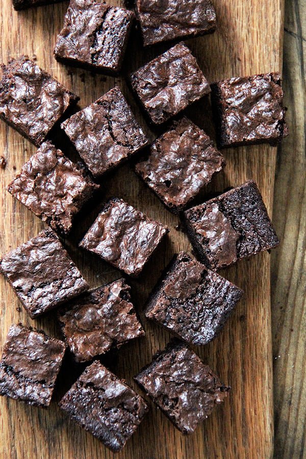 An overhead shot of cut, rich, fudgy brownie recipe on a board. 