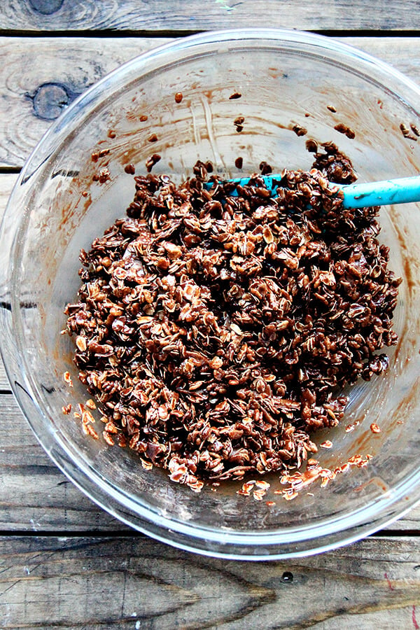 A large bowl of cocoa crunch being mixed up with a spatula.