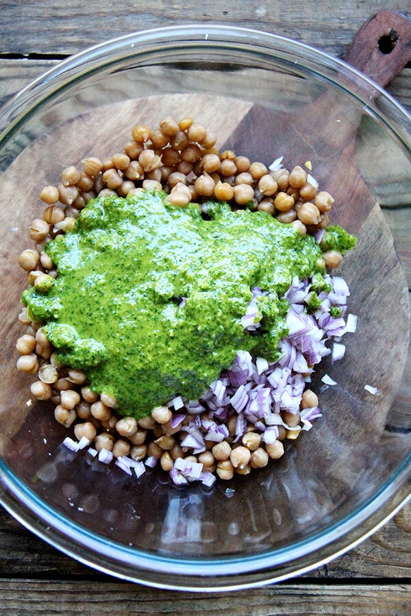 A large bowl filled with the chickpea salad ingredients and cilantro-lime dressing.