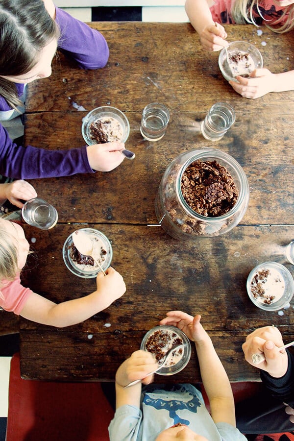 Overhead shot of kids eating homemade cocoa crunch at the table. 