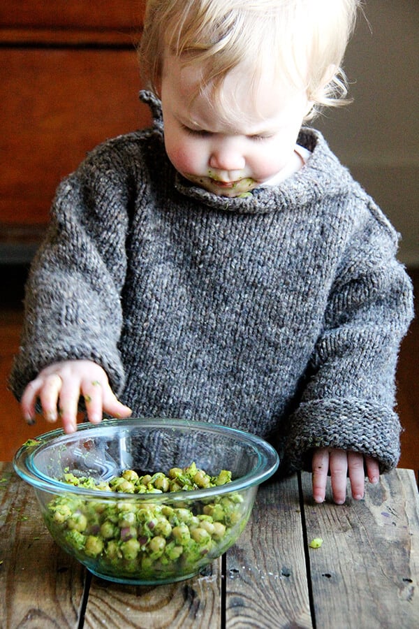 Baby eating cilantro-lime chickpeas.