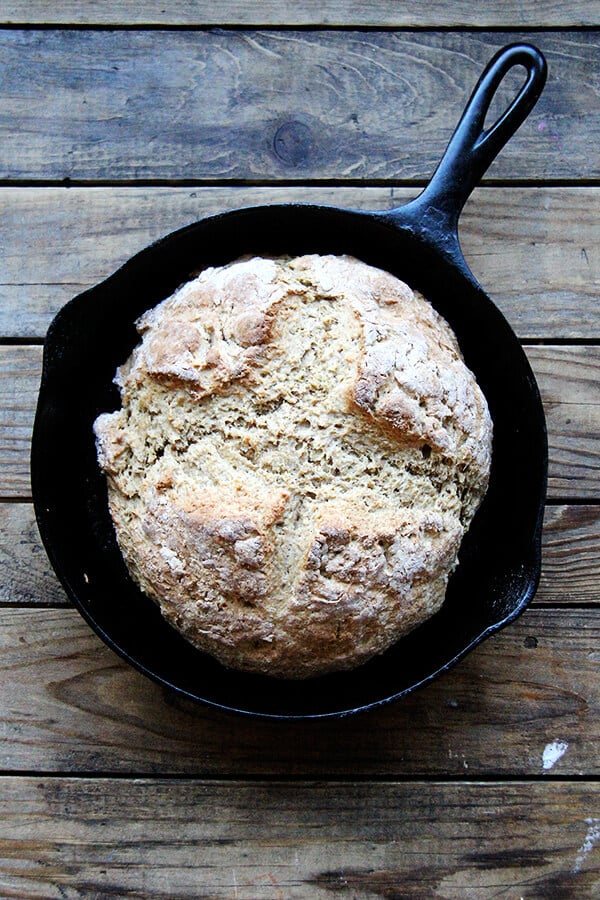 A cast iron skillet of just-baked whole wheat Irish soda bread.