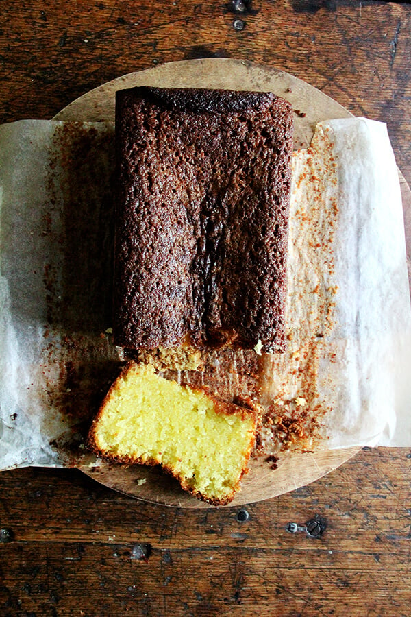 A loaf of lemon-semolina cake made with olive oil, sliced. 