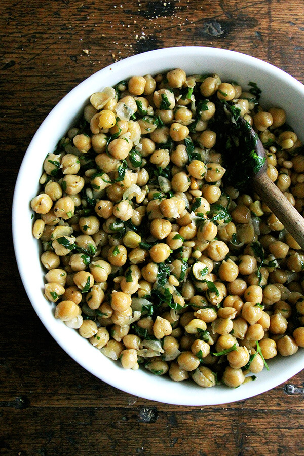 This recipe for chickpea saute with basil and pine nuts is inspired by the beautiful basil that has been arriving in our CSA: sweat garlic in extra-virgin olive oil, add cooked chickpeas, toasted pine nuts, and lots of salt, pepper, and chopped basil; sauté briefly; and serve immediately. Last Friday evening, a few friends came over for dinner, and we ate these chickpeas with grilled whole Branzino, focaccia, and a simple salad — it was a nice summer meal. // alexandracooks.com