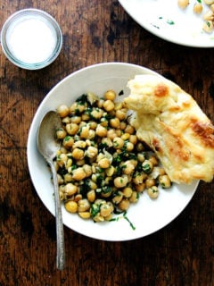 This recipe for chickpea saute with basil and pine nuts is inspired by the beautiful basil that has been arriving in our CSA: sweat garlic in extra-virgin olive oil, add cooked chickpeas, toasted pine nuts, and lots of salt, pepper, and chopped basil; sauté briefly; and serve immediately. Last Friday evening, a few friends came over for dinner, and we ate these chickpeas with grilled whole Branzino, focaccia, and a simple salad — it was a nice summer meal. // alexandracooks.com
