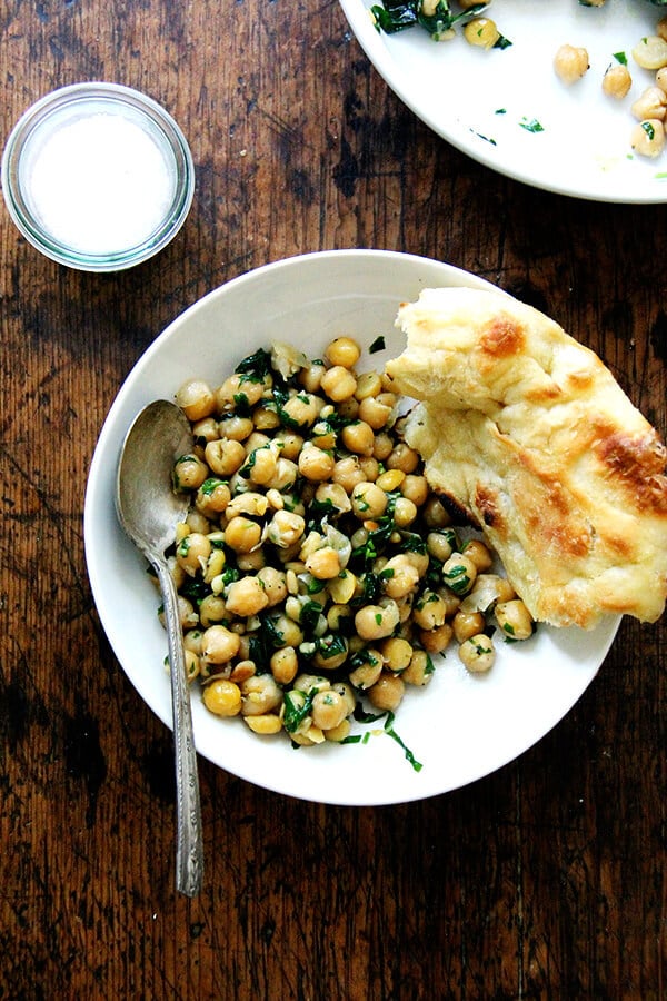 This recipe for chickpea saute with basil and pine nuts is inspired by the beautiful basil that has been arriving in our CSA: sweat garlic in extra-virgin olive oil, add cooked chickpeas, toasted pine nuts, and lots of salt, pepper, and chopped basil; sauté briefly; and serve immediately. Last Friday evening, a few friends came over for dinner, and we ate these chickpeas with grilled whole Branzino, focaccia, and a simple salad — it was a nice summer meal. // alexandracooks.com