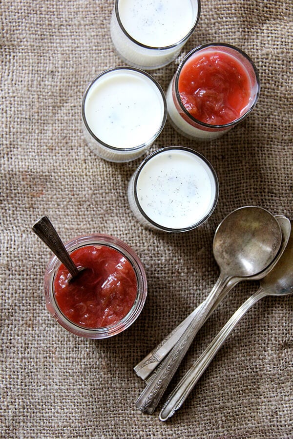 Overhead shot of buttermilk panna cotta with rhubarb compote and spoons. 
