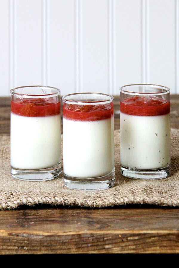 Three glasses of buttermilk panna cotta topped with rhubarb compote. 