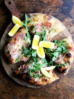 This prosciutto pizza is baked with a smear of crème fraîche and a layer of mozzarella, then topped with prosciutto and arugula out of the oven. It's very simple and very delicious. // alexandracooks.com