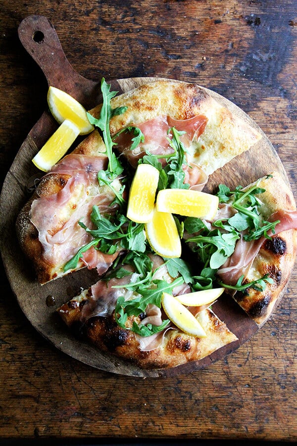 This prosciutto pizza is baked with a smear of crème fraîche and a layer of mozzarella, then topped with prosciutto and arugula out of the oven. It's very simple and very delicious. // alexandracooks.com