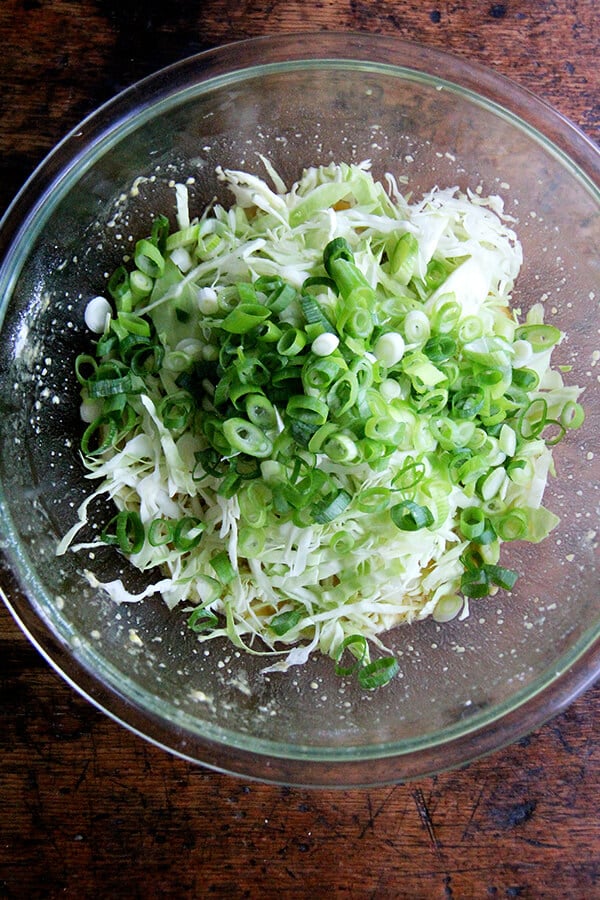cabbage and scallions in a large bowl