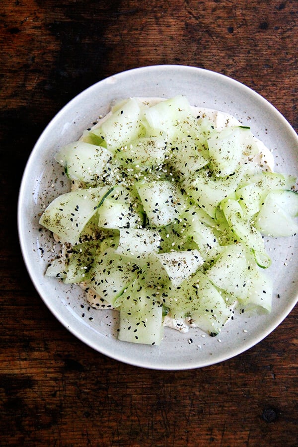 This cucumber salad with tahini-yogurt sauce essentially is a no-cook meal, a refreshing salad to make good use of those cool summer cucs, which might just be arriving in droves. I serve it along side broiled slices of ciabatta. Yum. // alexandracooks.com