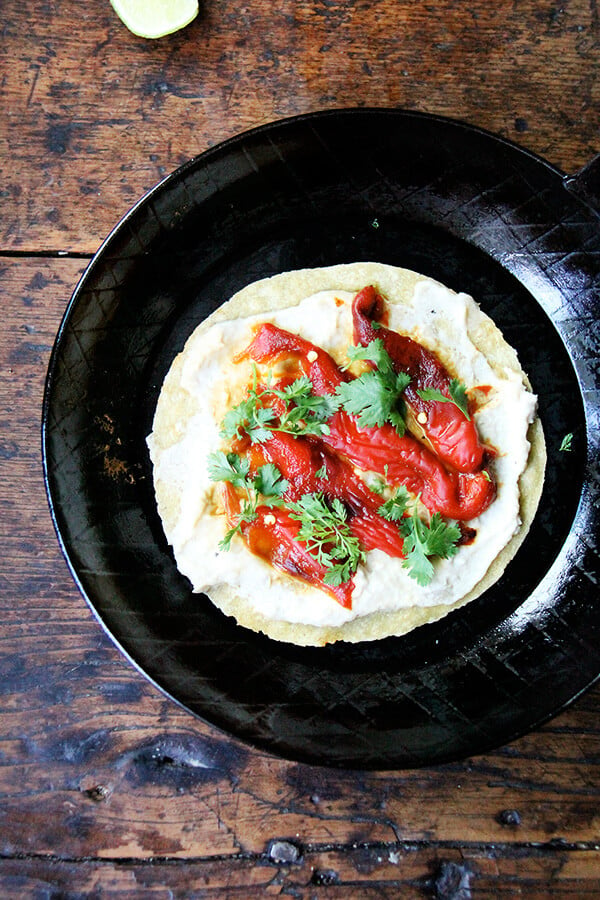 With a stash of peppers in the fridge, these roasted red pepper wraps come together in no time, and they're as easy to make for one as for a crowd. They're what I've been relying on as my motivation to do anything, namely cook, wanes with every degree out there it climbs. // alexandracooks.com