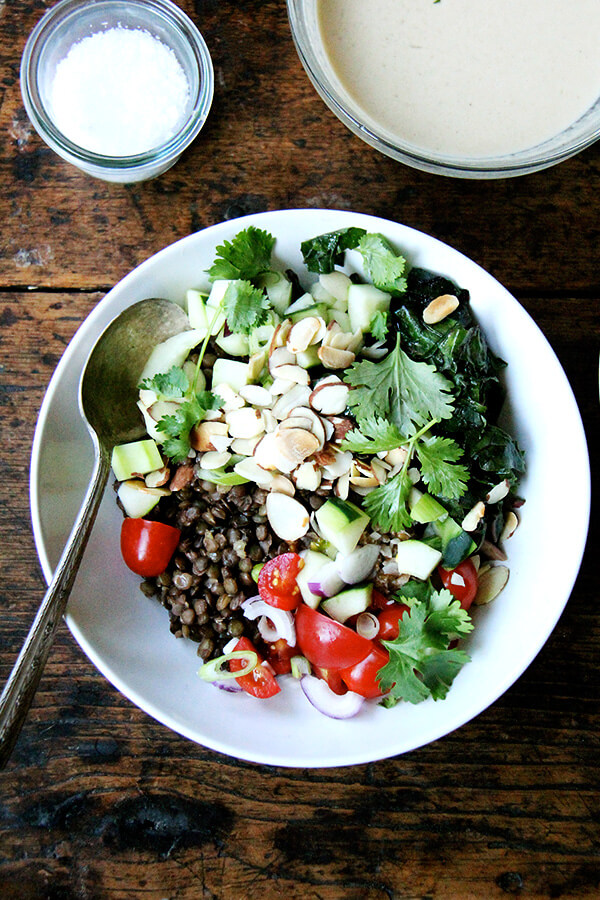 I can't seem to get enough of this bulgar bowl: a mix of bulgur and lentils, chopped cucumbers and tomatoes, toasted almonds, cilantro, and a lemon-tahini dressing. When you have some of the components prepared ahead of time, the assembly happens quickly! // alexandracooks.com
