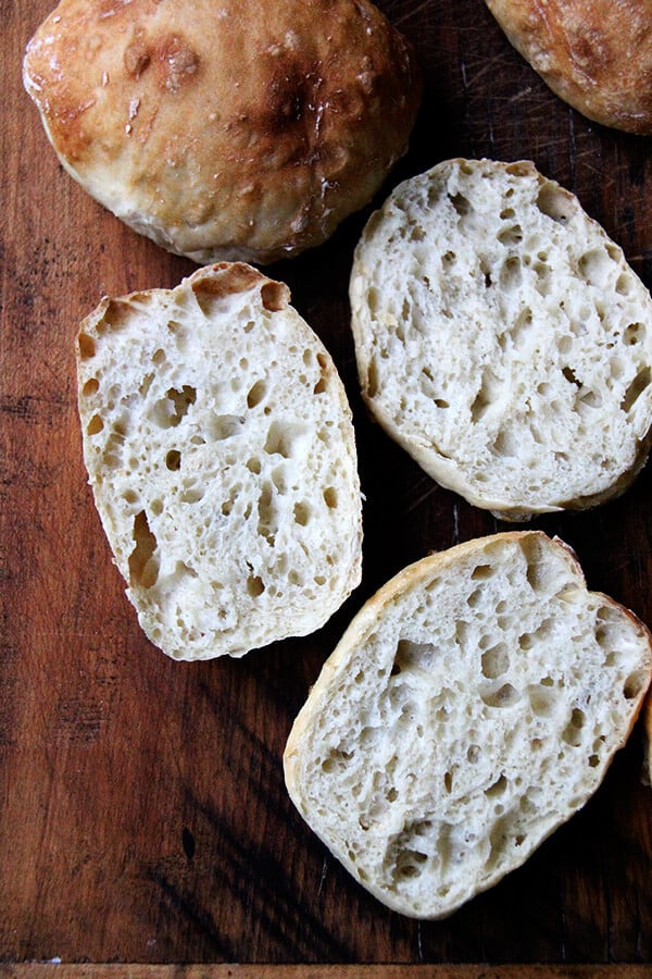 These sandwich rolls are a simple variation of the peasant bread recipe. If you take 5 minutes to mix the dough together this evening, you will be rewarded with the makings of a super-simple Friday night dinner, delicious vessels fit for flanking whatever your heart desires, but may I suggest balsamic-roasted eggplant and arugula? It's so good. // alexandracooks.com