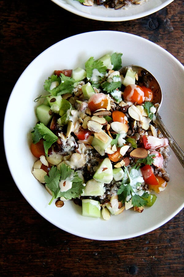 I can't seem to get enough of this bulgar bowl: a mix of bulgur and lentils, chopped cucumbers and tomatoes, toasted almonds, cilantro, and a lemon-tahini dressing. When you have some of the components prepared ahead of time, the assembly happens quickly! // alexandracooks.com