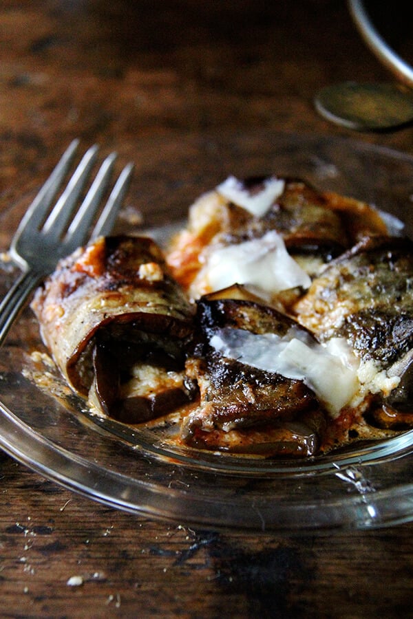 A plate of eggplant involtini and a fork.