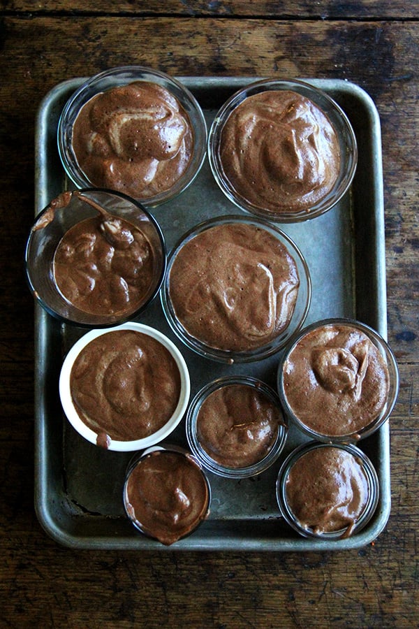 A sheet pan of bowls filled with homemade vegan chocolate mousse made with homemade aquafaba.