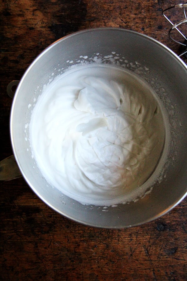 A stand mixer bowl filled with whipped homemade aquafaba.