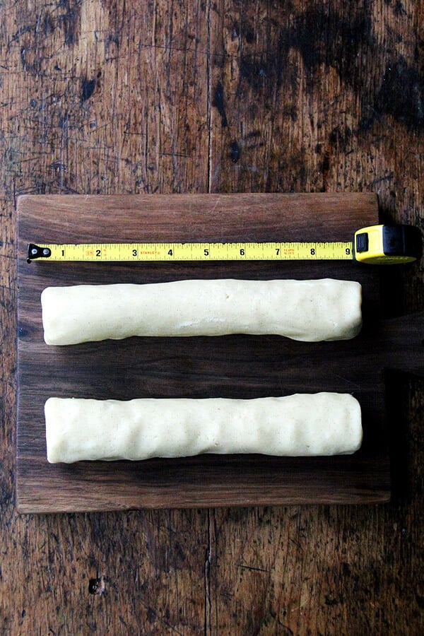 Two 9-inch sablé cookie dough logs on a cutting board.