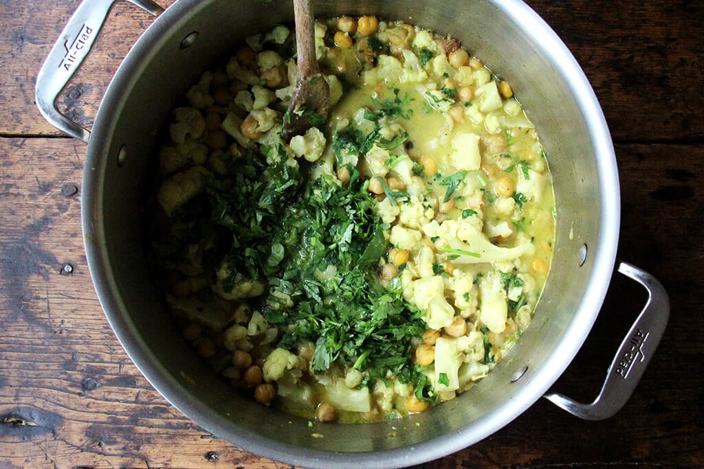 A pot of curried chickpeas with cilantro.