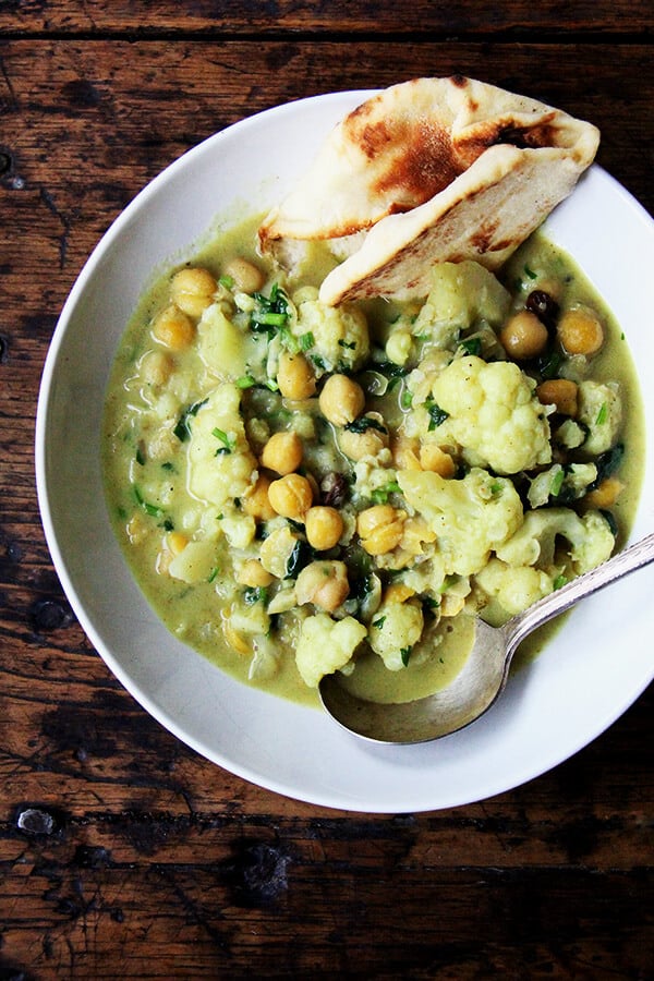 A pot of curried chickpeas with cauliflower and coconut milk.