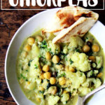 A bowl of curried chickpeas and cauliflower.