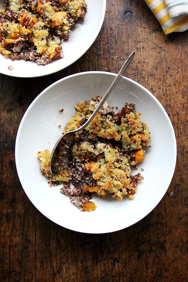 A bowl of just-baked quinoa bake with roasted butternut squash and onions.