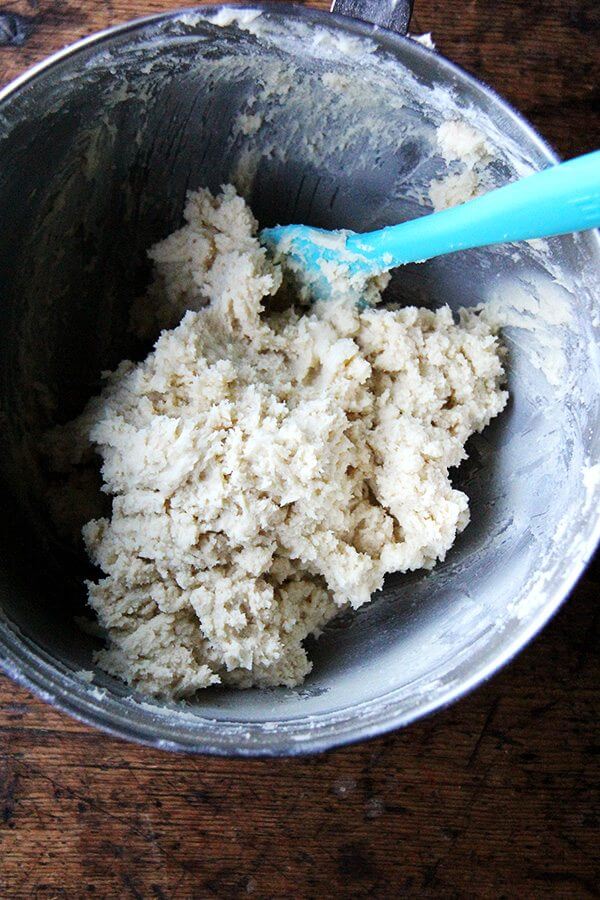 Classic cream cheese cookie dough in a stand mixer with a spatula. 