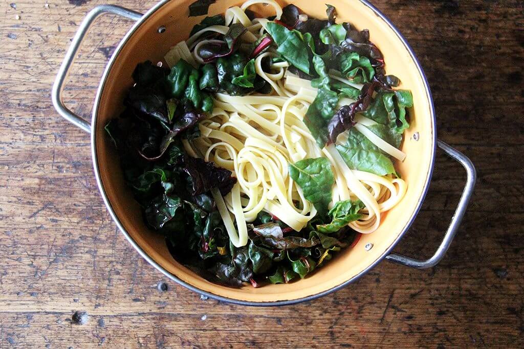 drained noodles over chard