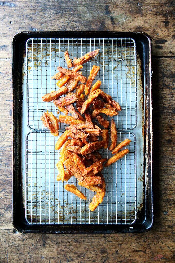 A tray of just fried thick-cut sweet potato fries.