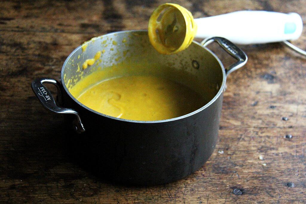 A pot with pureed butternut squash-sage sauce. 