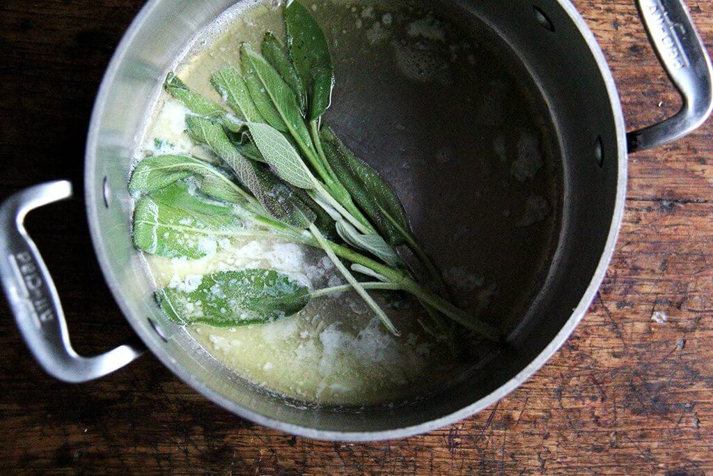 A pot with melted butter and sage. 