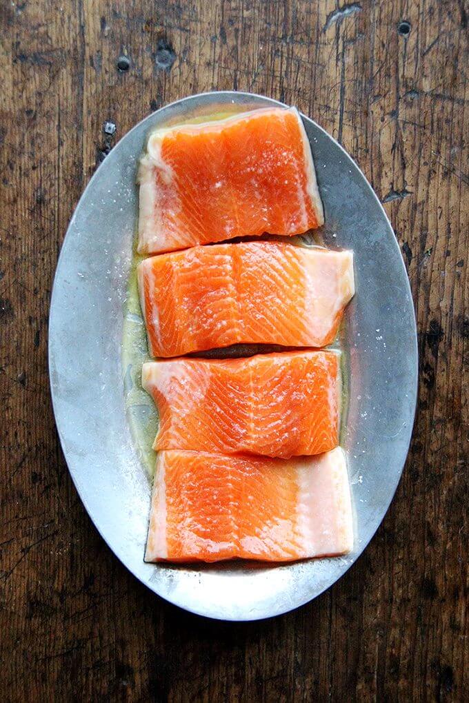 A sizzle platter holding filets of arctic char.