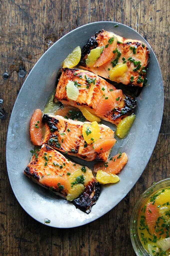 A sizzle platter holding broiled arctic char dressed in a citrus sauce.
