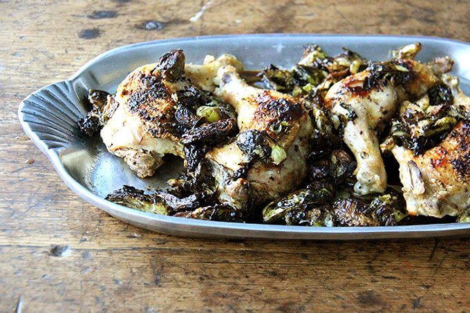 A platter of sheet pan chicken and Brussels sprouts. 