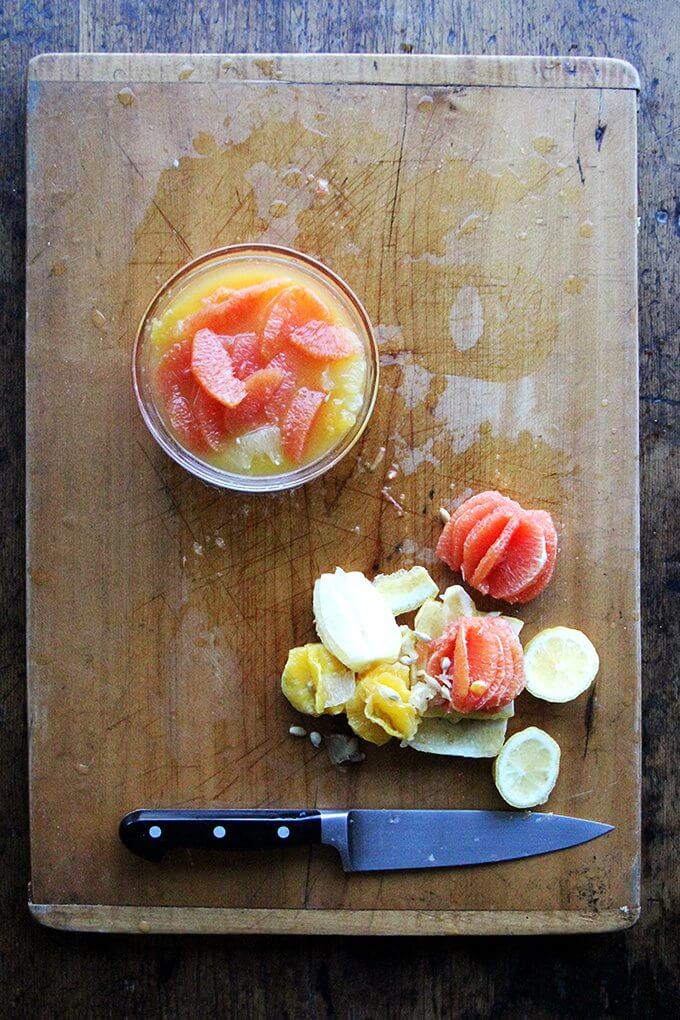 A board with citrus carcasses  and citrus sauce. 