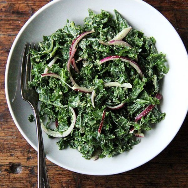 In this kale Cesar salad, the dressing is light and lemony and the kale itself is extremely soft and tender. It's also vegan, the dressing made with vegannaise and vegan Worcestershire. The combination of curly kale, massaged till tender, quick-pickled onions, and toasted pumpkin seeds, which add so much texture and flavor, is so good. I think this is one you have to taste to believe. // alexandracooks.com