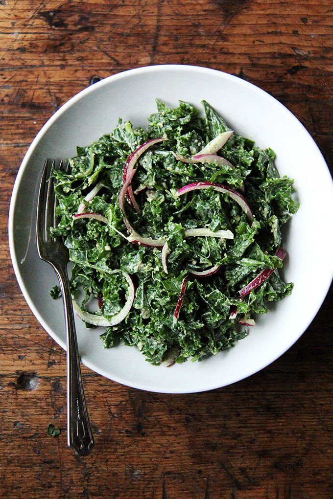 In this kale Cesar salad, the dressing is light and lemony and the kale itself is extremely soft and tender. It's also vegan, the dressing made with vegannaise and vegan Worcestershire. The combination of curly kale, massaged till tender, quick-pickled onions, and toasted pumpkin seeds, which add so much texture and flavor, is so good. I think this is one you have to taste to believe. // alexandracooks.com