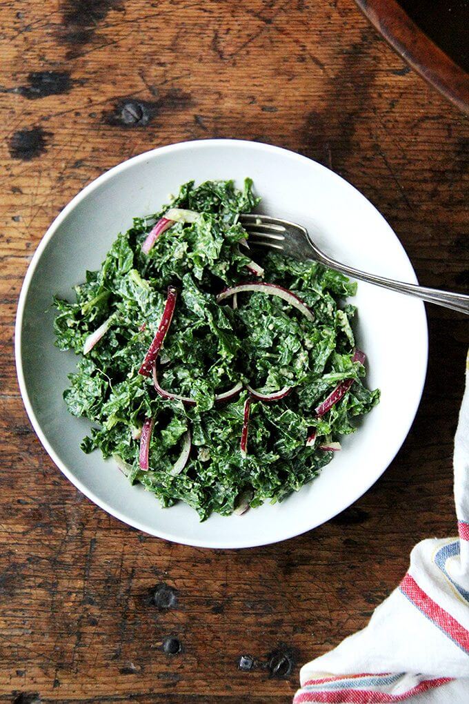 In this kale Cesar salad, the dressing is light and lemony and the kale itself is extremely soft and tender. It's also vegan, the dressing made with vegannaise and vegan Worcestershire. The combination of curly kale, massaged till tender, quick-pickled onions, and toasted pumpkin seeds, which add so much texture and flavor, is so good. I think this is one you have to taste to believe. // alexandracooks.com