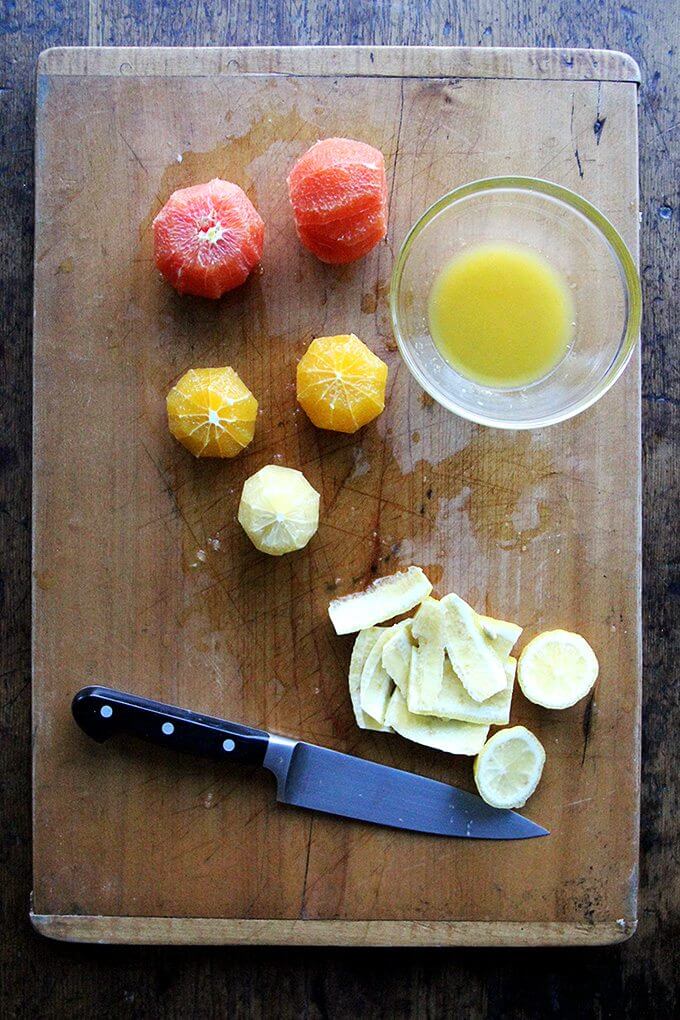 A board with peeled citrus fruit. 