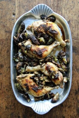 A platter of sheet pan roast chicken and Brussels sprouts.