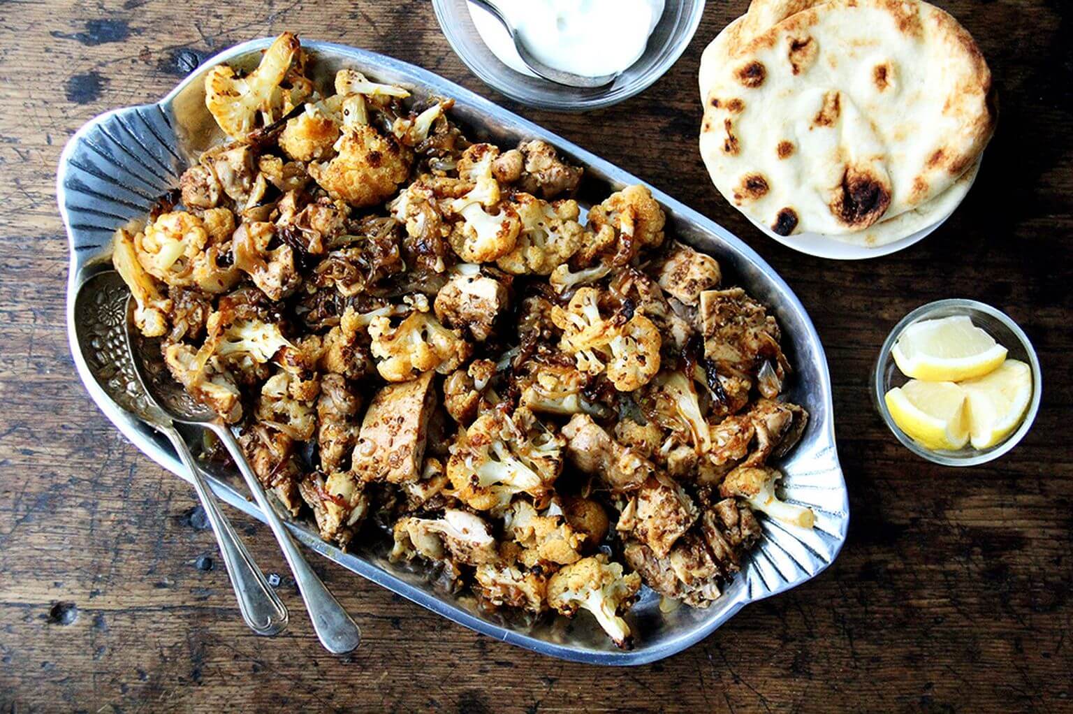 A platter of sheet pan chicken and cauliflower shawarma. 