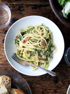 If you're looking for something to make for Valentine's Day, this bucatini carbonara couldn't be simpler to throw together: cook bacon, reserve the fat, use the fat to cook leeks; boil pasta, toss with eggs, fresh lemon juice, grated parmesan, and a little bit of pasta cooking liquid. Toss it all together, add some fresh parsley, and serve with more parmesan and lots of pepper. That's it! // alexandracooks.com