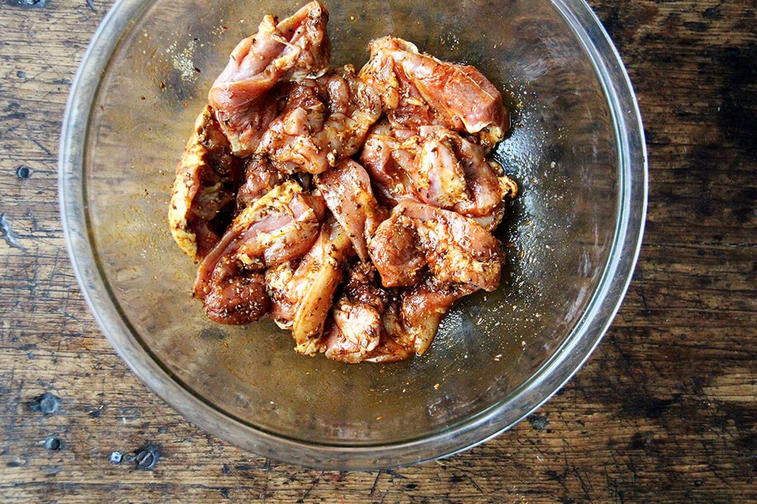 A bowl of chicken seasoned with shawarma spices.